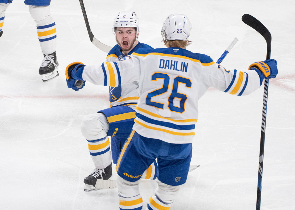 Buffalo Sabres' Zach Benson (6) celebrates his goal over Montreal Canadiens with teammate Rasmus Dahlin (26) during third period, second round, game 4, NHL playoff action in Montreal on Tuesday, May 12, 2026. (Christinne Muschi/The Canadian Press via AP)