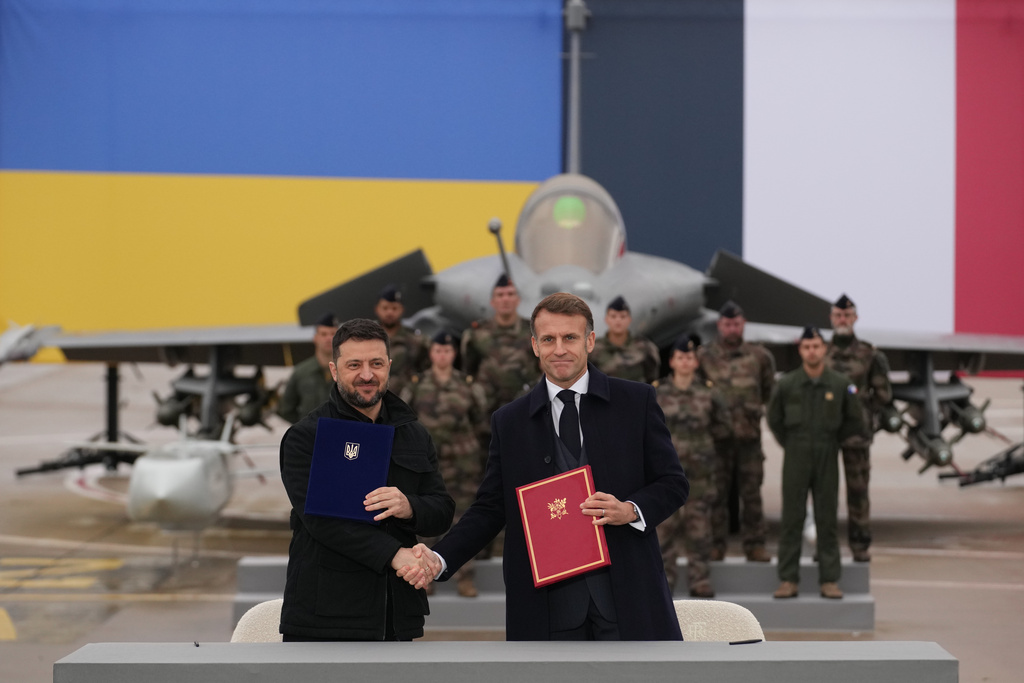 French President Emmanuel Macron, right, and Ukrainian President Volodymyr Zelenskyy shake hands after signing an agreement Monday, Nov. 17, 2025 at the Villacoublay air base near Paris. (AP Photo/Christophe Ena, Pool)