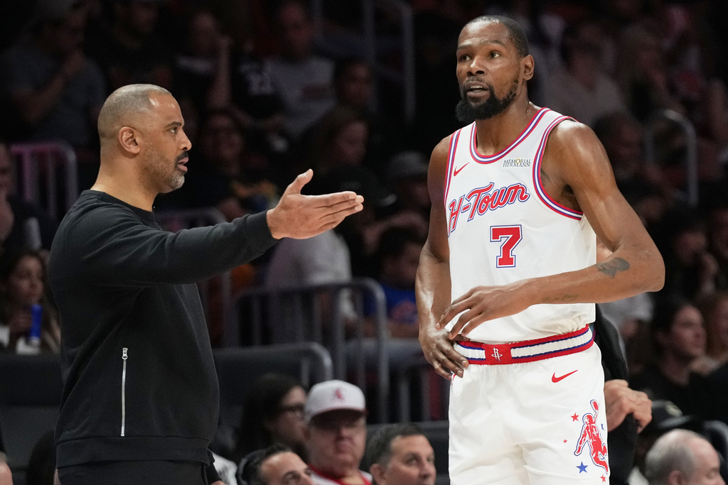 Houston Rockets forward Kevin Durant (7) talks with head coach Ime Udoka, left, during the second half of an NBA basketball game against the Miami Heat, Saturday, Feb. 28, 2026, in Miami. (AP Photo/Lynne Sladky)