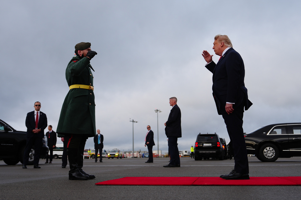 U.S. President Donald Trump, right, salutes from the red carpet after disembarking Air Force One at Dublin Airport in Dublin, Saturday, Sept. 12, 2026. (AP Photo/Julia Demaree Nikhinson)