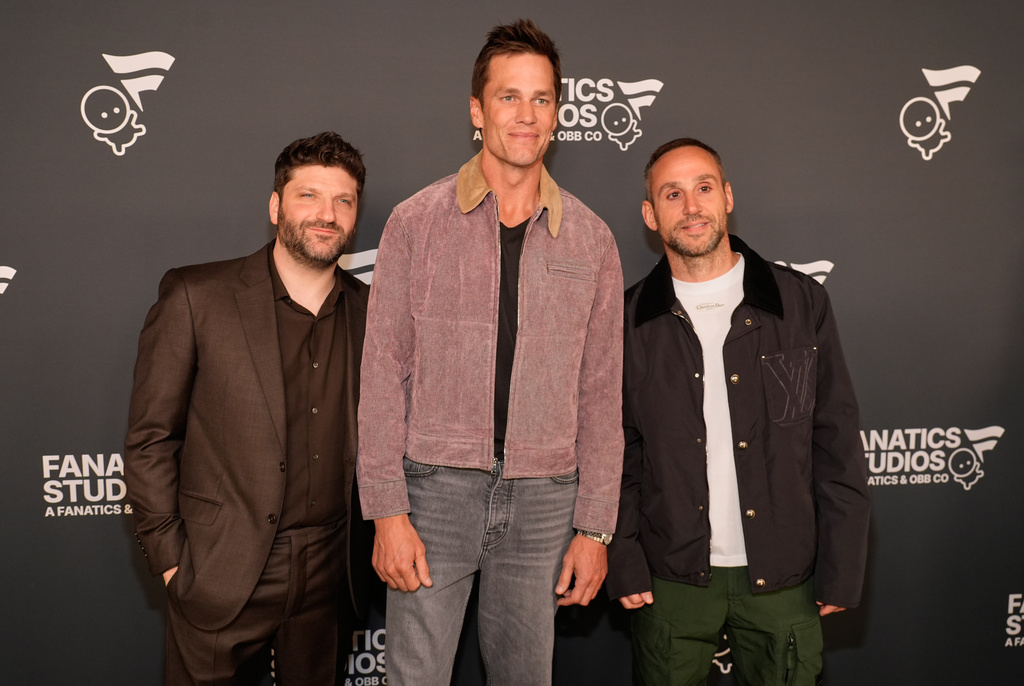 Tom Brady, center, poses with Michael D. Ratner, left, founder and CEO of OBB Media and CEO of Fanatics Studio, and Fanatics founder Michael Rubin at the launch party for Fanatics Studio, a global studio for sports entertainment, on Tuesday, Jan. 13, 2026, at the Intuit Dome in Inglewood, Calif. (AP Photo/Chris Pizzello)