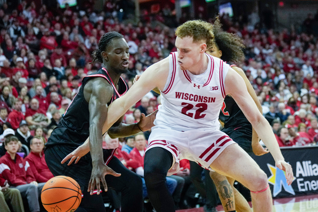 Rutgers' Chris Nwuli (11) knocks the ball loose from Wisconsin's Austin Rapp (22) during the second half of an NCAA college basketball game Saturday, Jan. 17, 2026, in Madison, Wis. (AP Photo/Andy Manis)