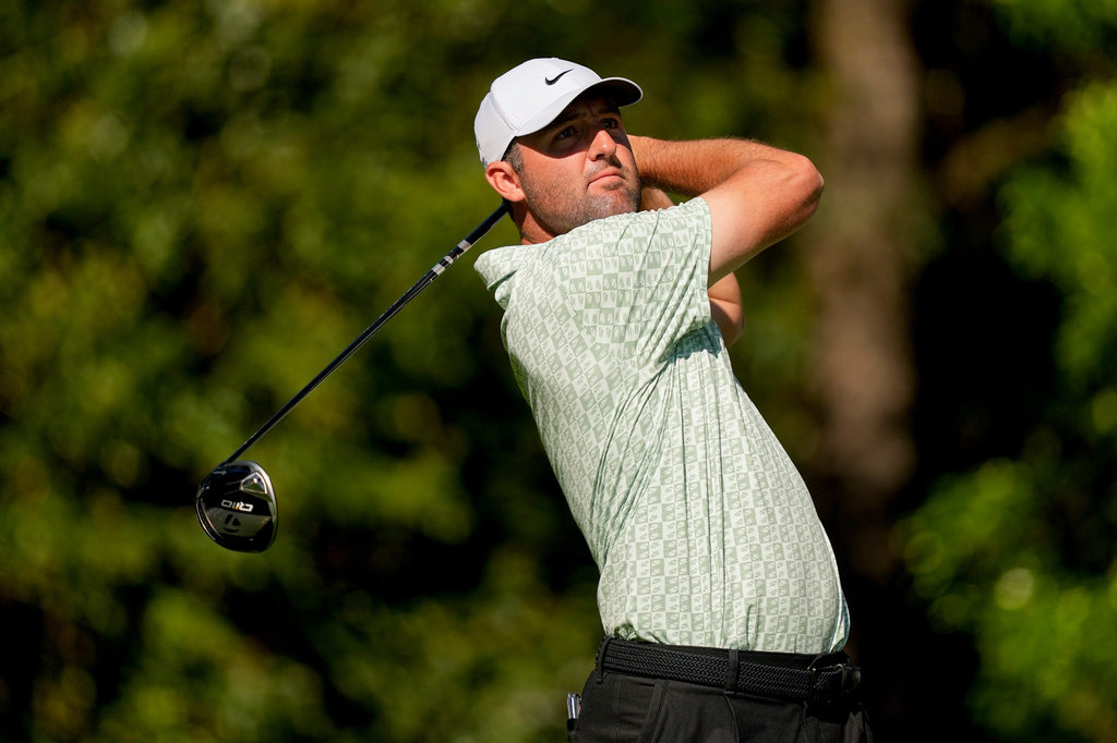Scottie Scheffler watches his tee shot on the 11th hole during the first round of the Masters golf tournament at the Augusta National Golf Club, Thursday, April 9, 2026, in Augusta, Ga. (AP Photo/Gerald Herbert)
