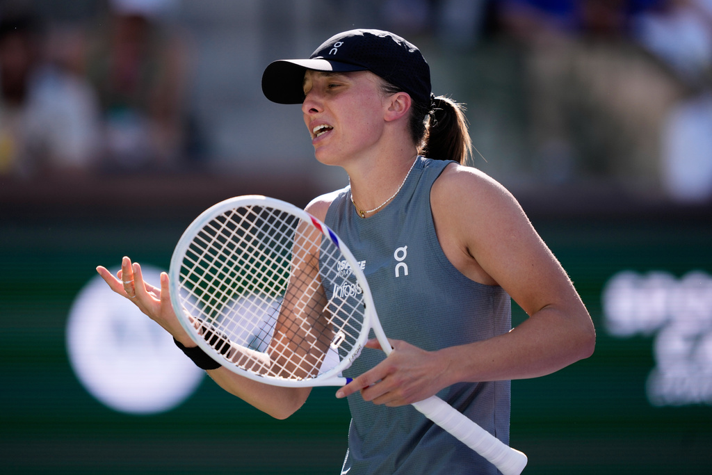 Iga Swiatek, of Poland, reacts after losing a point against Elina Svitolina, of Ukraine, during a quarterfinal match at the BNP Paribas Open tennis tournament, Thursday, March 12, 2026, in Indian Wells, Calif. (AP Photo/Mark J. Terrill)
