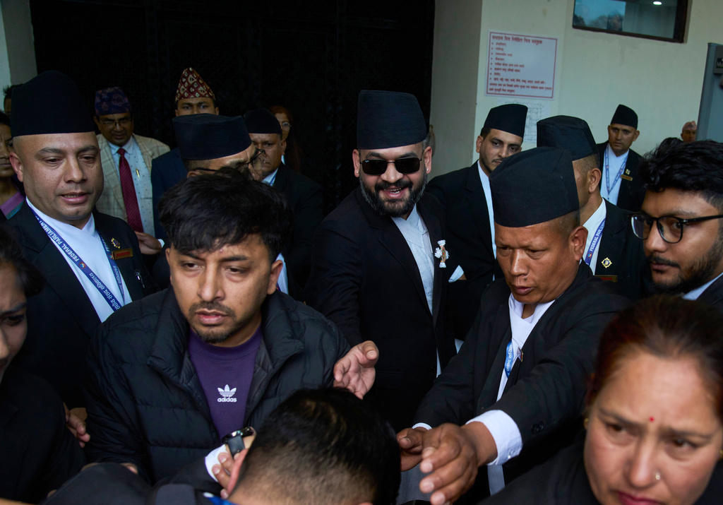 Balendra Shah, center with sun glasses, arrives for a swearing-in ceremony of newly elected members of the House of Representatives at the Federal Parliament in Kathmandu, Nepal, Thursday, March 26, 2026. (AP Photo/Niranjan Shrestha)