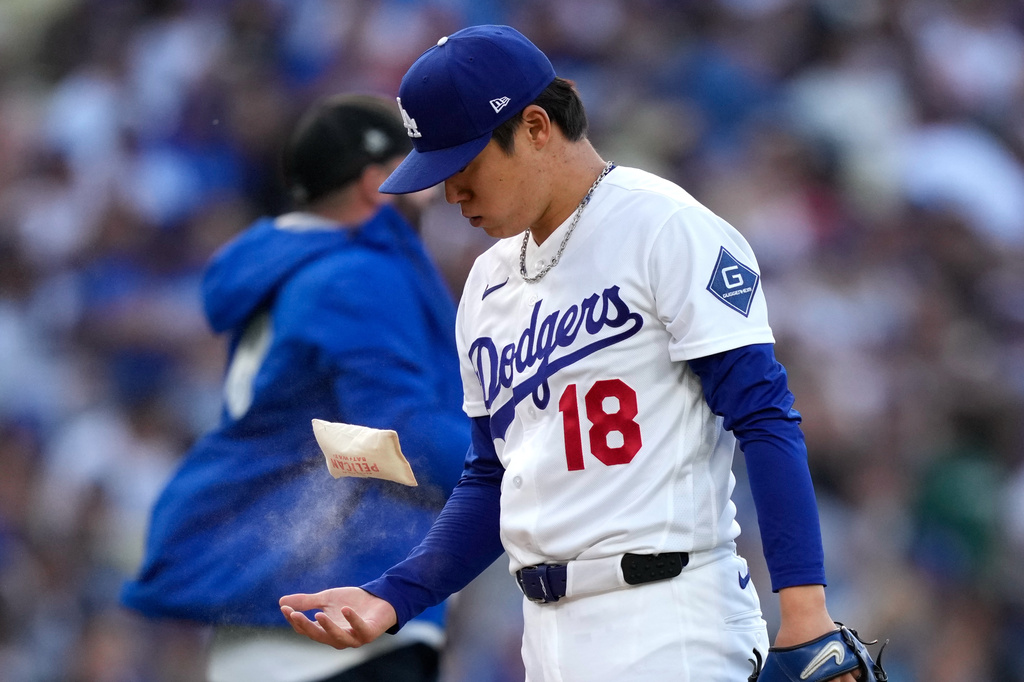 Los Angeles Dodgers pitcher Yoshinobu Yamamoto picks up a rosin bag prior to the first inning of a baseball game against the San Francisco Giants, Tuesday, May 12, 2026, in Los Angeles. (AP Photo/Mark J. Terrill)