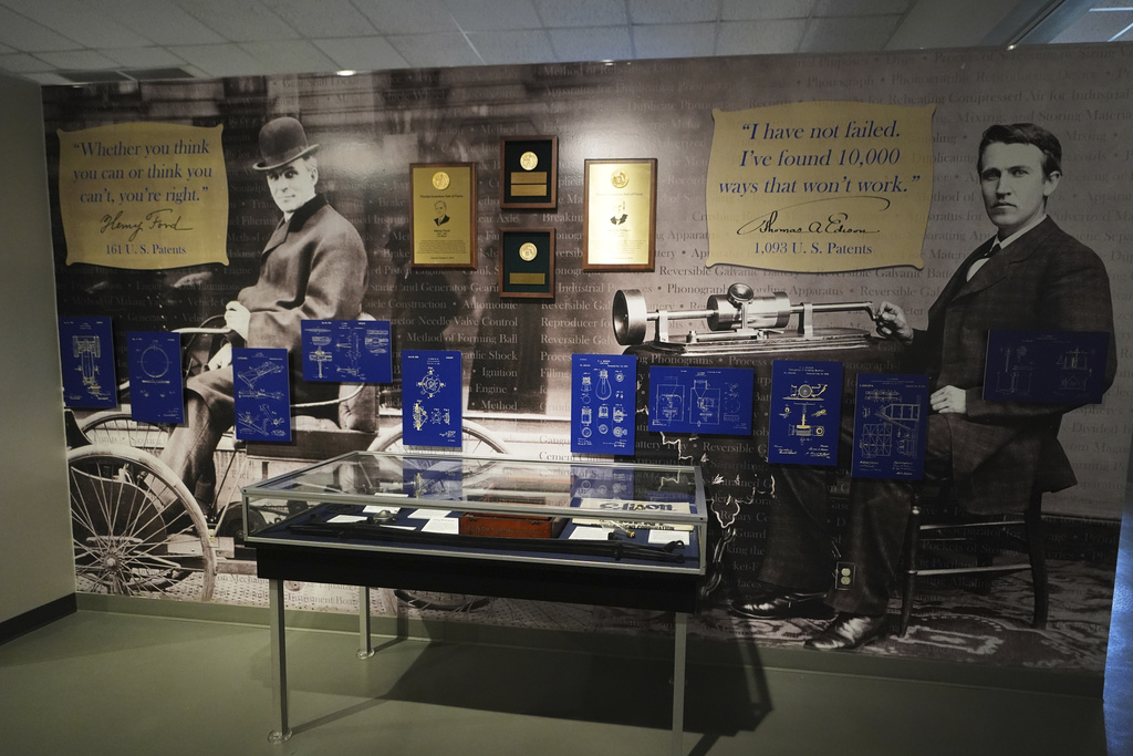 Pictures of Henry Ford, left, and Thomas Edison, right, are displayed in a museum, Saturday, Aug. 9, 2025, at the Edison and Ford Winter Estates, purchased in 1885 by Edison, and later Ford purchased the adjoining property, in Fort Myers, Fla. (AP Photo/Lynne Sladky)