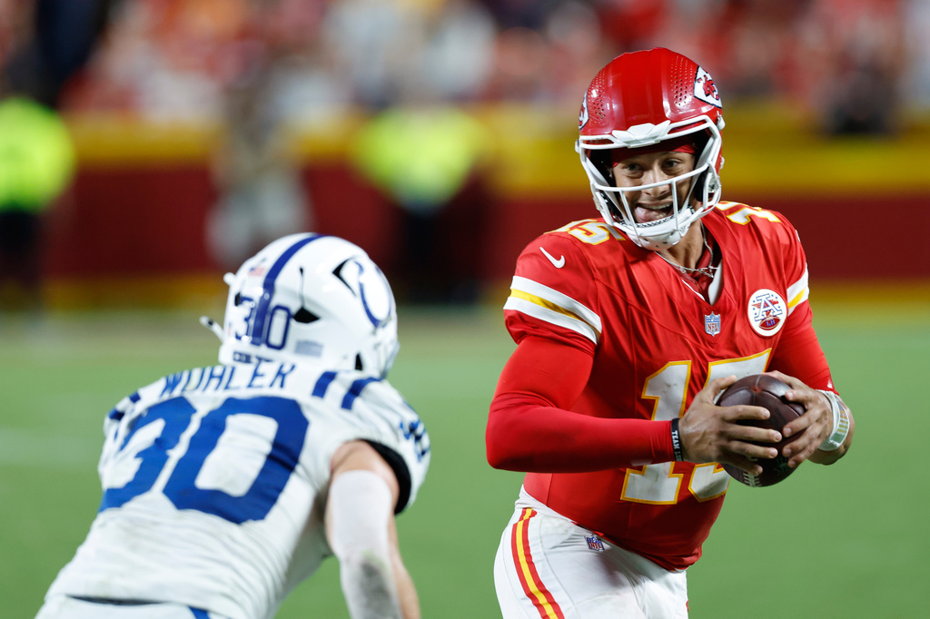 Kansas City Chiefs quarterback Patrick Mahomes (15) runs for a first down as Indianapolis Colts safety Hunter Wohler (30) defends during overtime of an NFL football game Sunday, Sept. 20, 2026, in Kansas City, Mo. (AP Photo/Colin E. Braley)