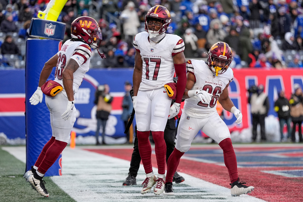 Washington Commanders wide receiver Terry McLaurin (17) celebrates with teammates after scoring a touchdown against the New York Giants during the fourth quarter of an NFL football game, Sunday, Dec. 14, 2025, in East Rutherford, N.J. (AP Photo/Yuki Iwamura)