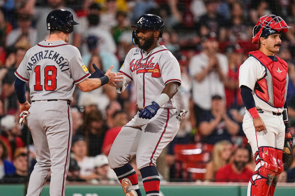 Atlanta Braves' Michael Harris II, center, is congratulated by Mike Yastrzemski (18) after his two-run home run, as Boston Red Sox's Mickey Gasper (30) waits for play to resume, during the eighth inning of a baseball game, Tuesday, May 26, 2026, in Boston. (AP Photo/Charles Krupa)