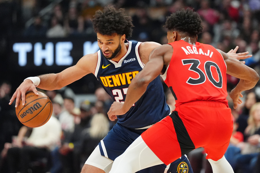 Denver Nuggets guard Jamal Murray (27) tries to get around Toronto Raptors guard Ochai Agbaji (30) during first half NBA action in Toronto on Wednesday Dec. 31, 2025. (Frank Gunn/The Canadian Press via AP)