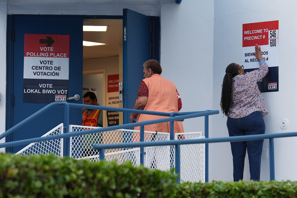 Poll workers prepare ahead of the opening of a voting site at Miami City Hall, on Election Day, Tuesday, Nov. 4, 2025, in Miami. (AP Photo/Rebecca Blackwell)
