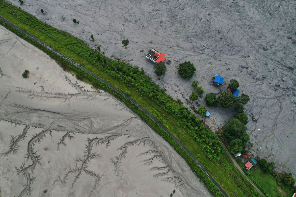 A drone view shows a major section of Pasang Lhamu highway washed away along swollen Trishuli river by recent flash floods cutting off Rasuwa district from Nuwakot area, Nepal, Monday, Aug. 31, 2026. (AP Photo/Rajesh Kumar Singh)
