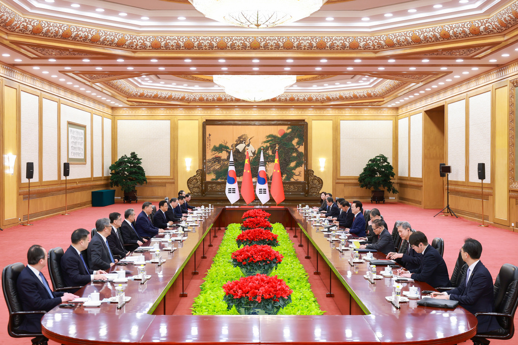 In this photo released by Xinhua News Agency, Chinese President Xi Jinping, sixth left, talks to South Korean President Lee Jae Myung, sixth right, during the bilateral meeting at the Great Hall of the People, in Beijing, Monday, Jan. 5, 2026. (Liu Bin/Xinhua via AP)