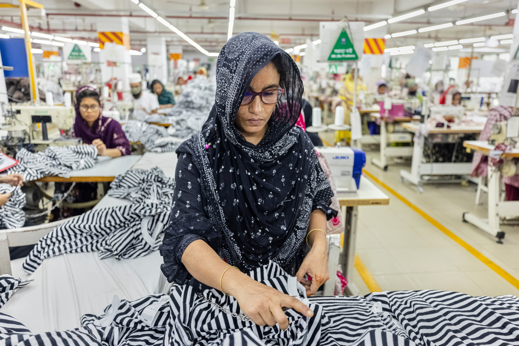 An employee wears her prescription eyeglasses while working at a garment factory in Gazipur, on the outskirts of Dhaka, Bangladesh, June 30, 2026. (AP Photo/Rajib Dhar)