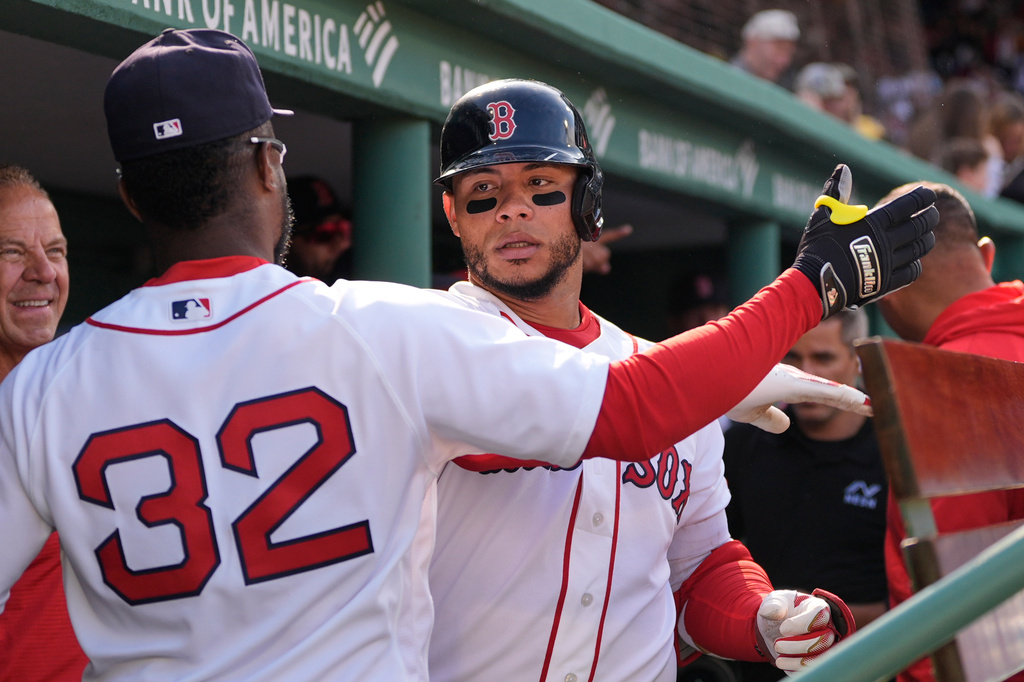 Boston Red Sox's Willson Contreras, right, celebrates with Andruw Monasterio (32) after hitting a solo home run against the San Diego Padres during the sixth inning on a home-opener baseball game at Fenway Park, Friday, April 3, 2026, in Boston. (AP Photo/Charles Krupa)
