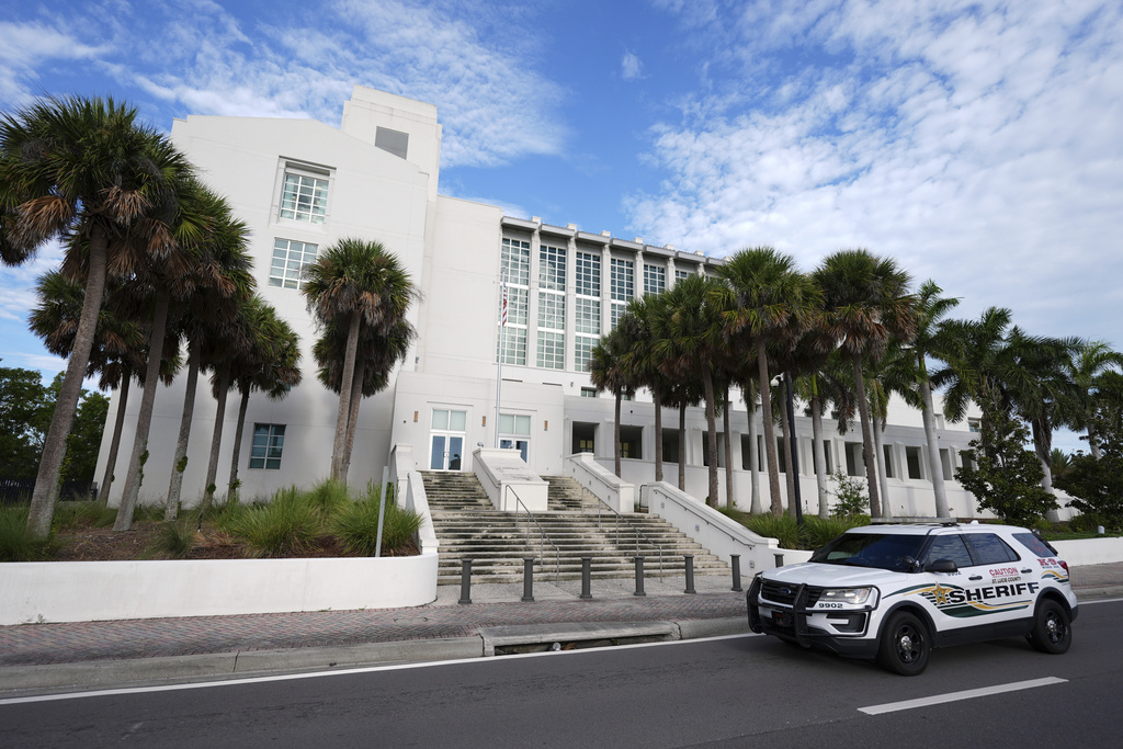 A police car drives past the Alto Lee Adams Sr. U.S. Courthouse as jury selection began in the trial of Ryan Routh, charged with trying to assassinate Donald Trump while he played golf last year in South Florida, Monday, Sept. 8, 2025, in Fort Pierce, Fla. (AP Photo/Rebecca Blackwell)