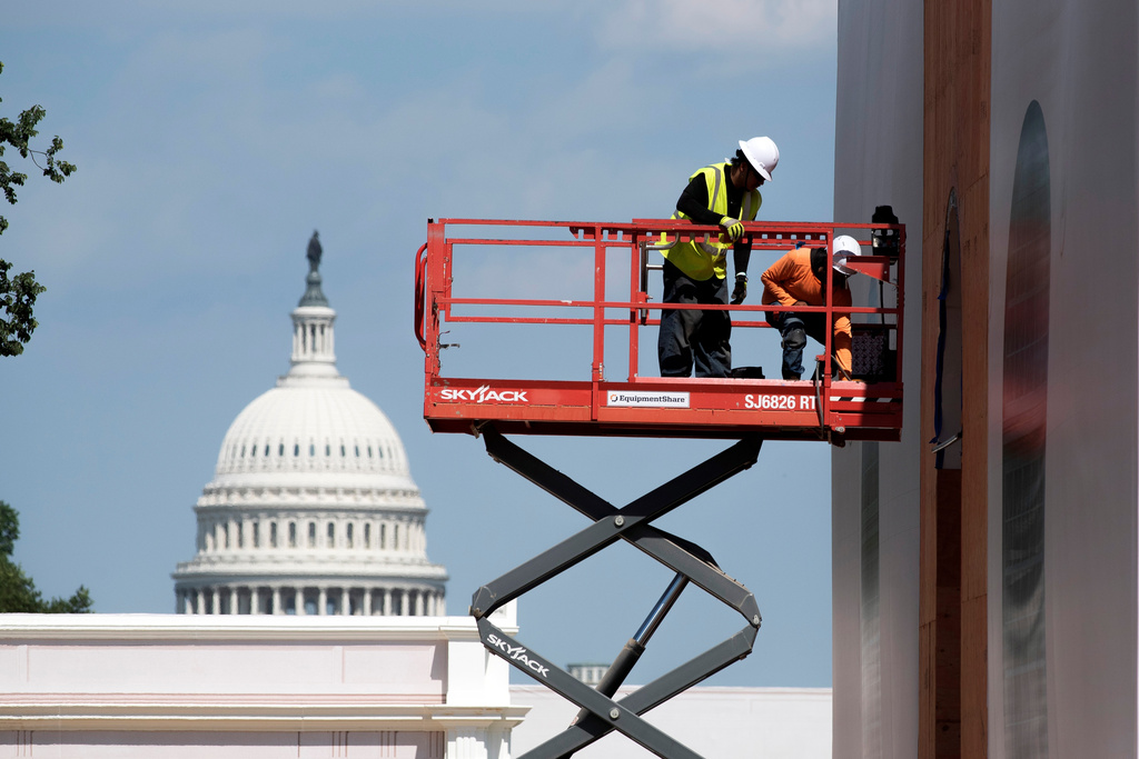 Workers work on a State's pavilion for the Great American State Fair, on the National Mall in Washington, Wednesday, June 17, 2026. (AP Photo/Cliff Owen)
