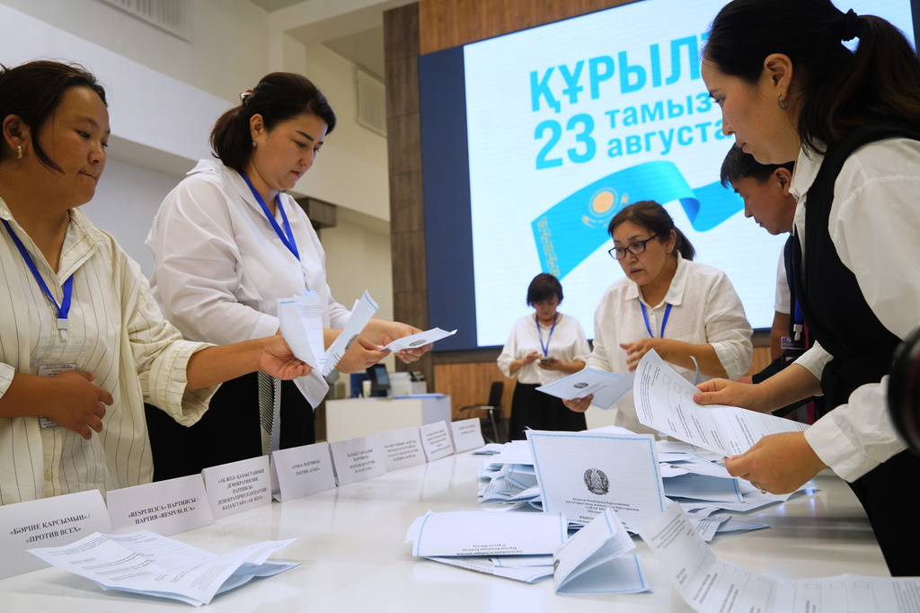 Election commission members count ballots at a polling station during early parliamentary elections in Almaty, Kazakhstan, Sunday, Aug. 23, 2026. (AP Photo/Vladimir Tretyakov)