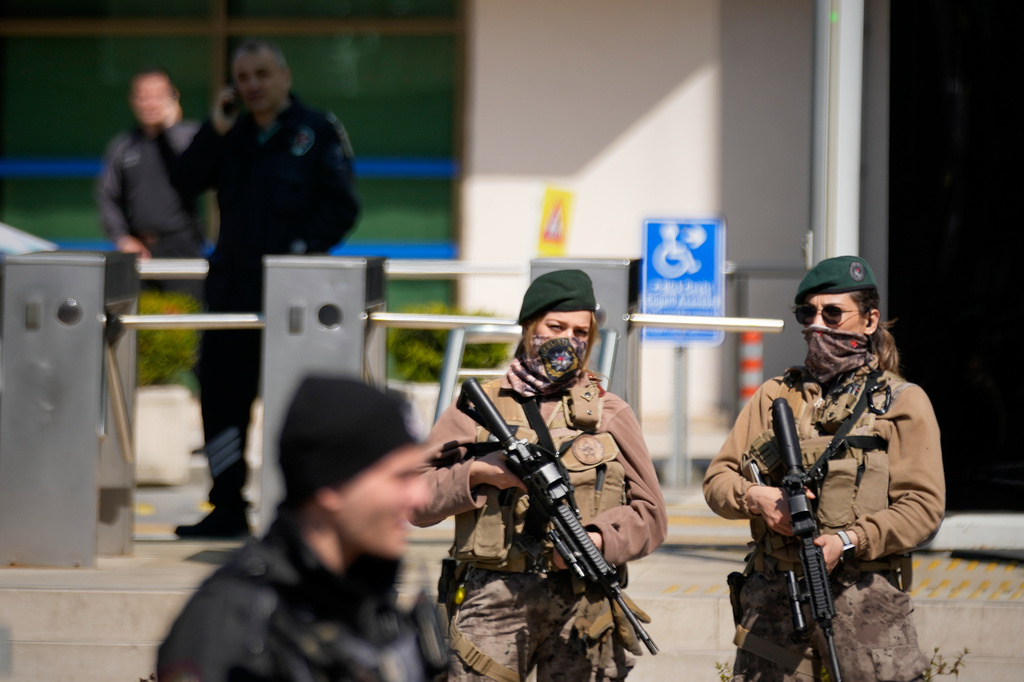 Turkish police and army secure the area after a gunmen attack at a building housing the Israeli Consulate in Istanbul, Turkey, Tuesday, April 7, 2026. (AP Photo/Khalil Hamra)
