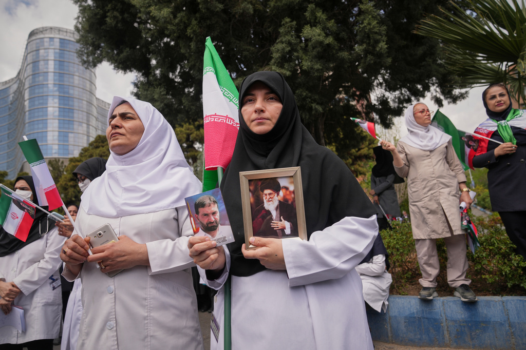 Medical workers attend a government-sponsored protest against the U.S.-Israeli military campaign outside Imam Khomeini Hospital in Tehran, Iran, Monday, April 6, 2026. (AP Photo/Francisco Seco)