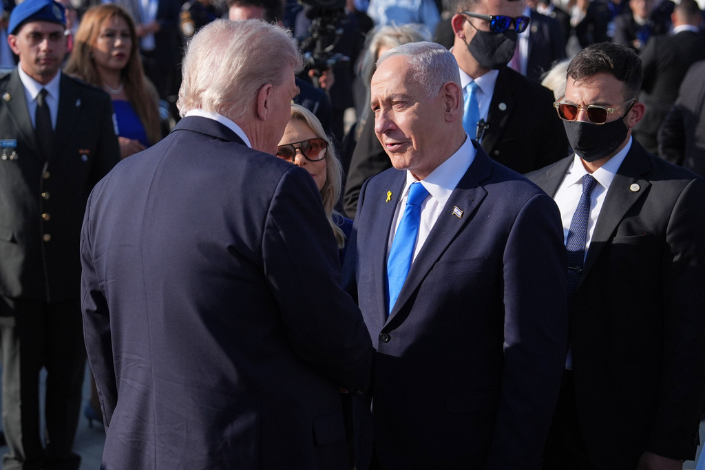 President Donald Trump talks with Israel's Prime Minister Benjamin Netanyahu before he boards Air Force One at Ben Gurion International Airport, Monday, Oct. 13, 2025, near Tel Aviv. (AP Photo/Evan Vucci)