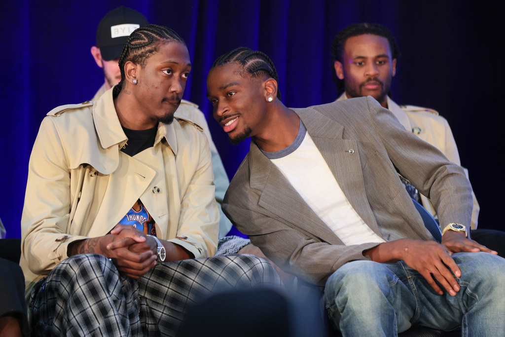 Oklahoma City Thunder guard Shai Gilgeous-Alexander, right, talks to guard Jalen Williams, left, before a news conference after Gilgeous-Alexander was named the NBA basketball MVP as guard Cason Wallace, back right, looks on, Sunday, May 17, 2026, in Oklahoma City. (AP Photo/Nate Billings)