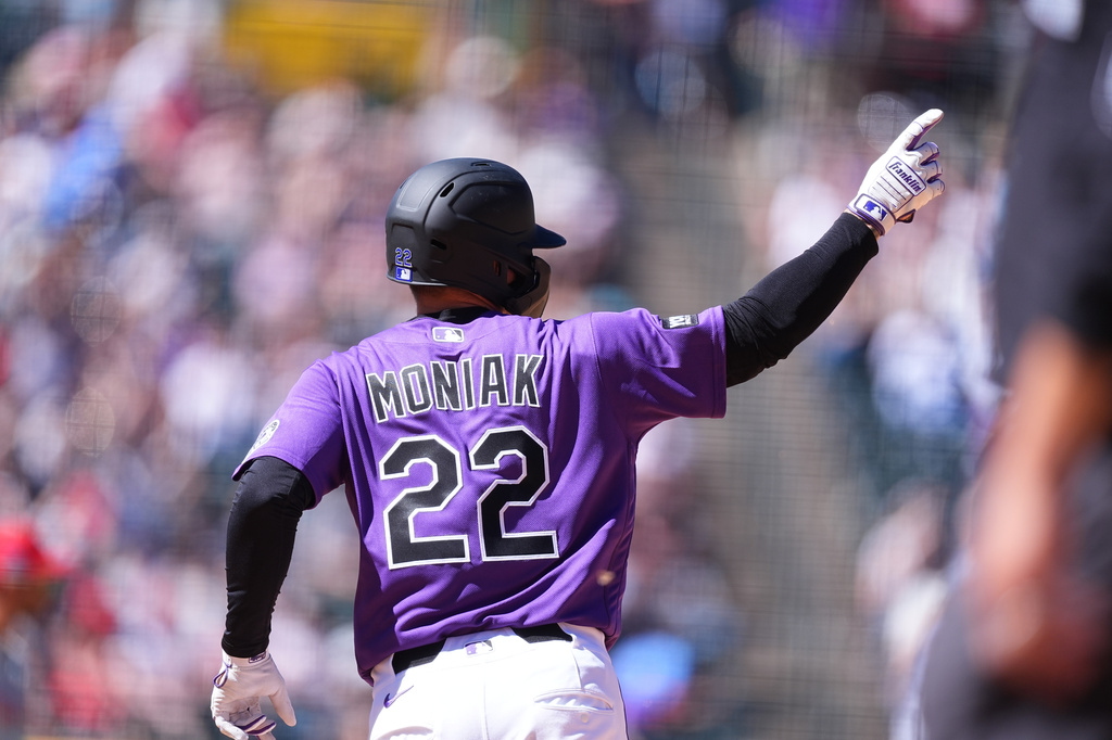 Colorado Rockies' Mickey Moniak gestures to the bullpen as he circles the bases after hitting a solo home run off Philadelphia Phillies starting pitcher Taijuan Walker in the fifth inning of a baseball game Sunday, April 5, 2026, in Denver. (AP Photo/David Zalubowski)