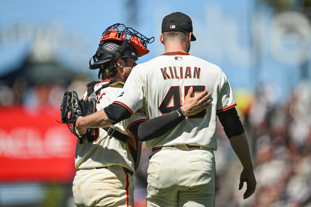 San Francisco Giants' Eric Haase, left, and Caleb Kilian, right, hug after their team defeated the Atlanta Braves in a baseball game, Sunday, June 28, 2026, in San Francisco (AP Photo/Justine Willard)