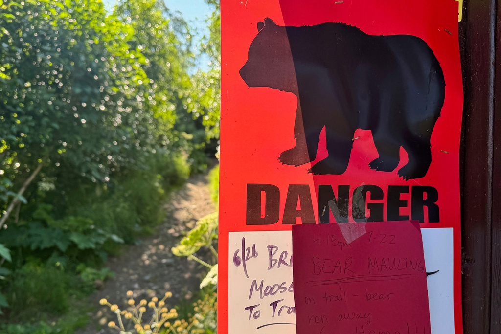 FILE - A bear warning sign is posted at the Basher trailhead in Anchorage, Alaska, on July 23, 2025. (AP Photo/Mark Thiessen, File)