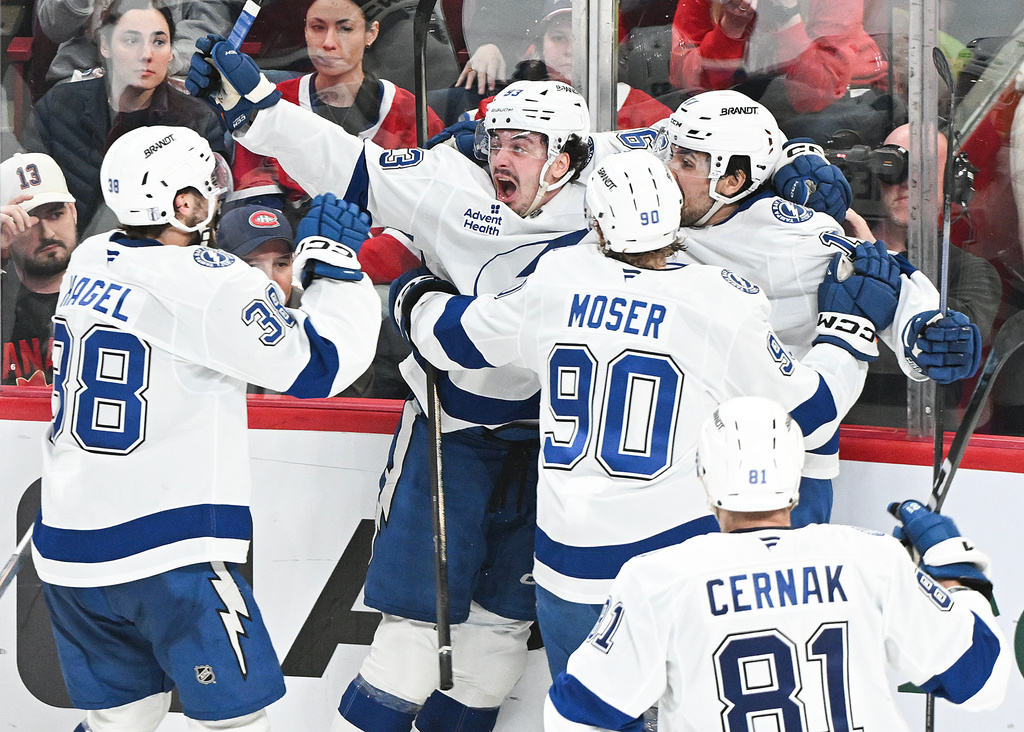 Tampa Bay Lightning's Gage Goncalves, second from left, celebrates with teammates after scoring against the Montreal Canadiens during overtime of Game 6 in the first round of an NHL hockey Stanley Cup playoff series in Montreal, Friday, May 1, 2026. (Graham Hughes/The Canadian Press via AP)