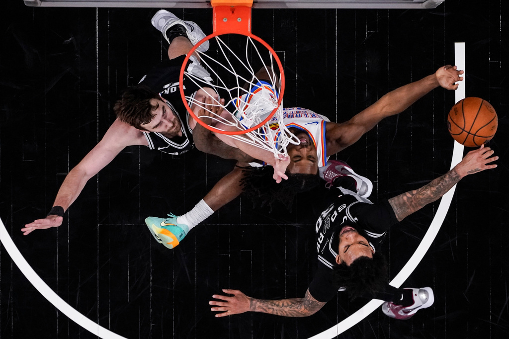 Oklahoma City Thunder guard Cason Wallace (22) shoots against San Antonio Spurs forward Julian Champagnie (30) in the second half of Game 6 in the Western Conference finals NBA basketball playoffs series, Thursday, May 28, 2026, in San Antonio. (AP Photo/David J. Phillip)