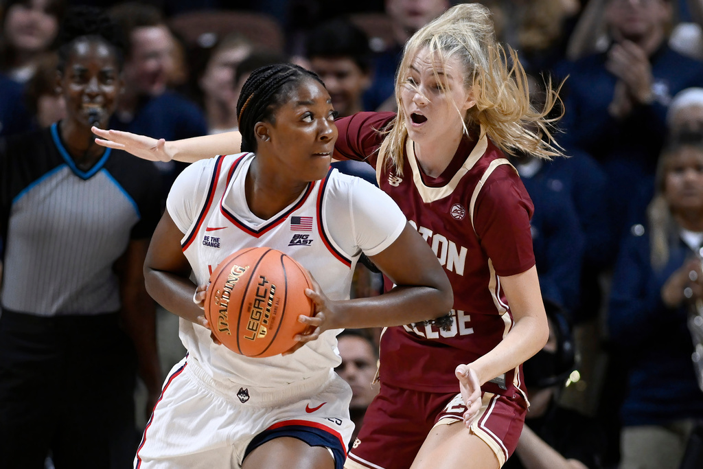 UConn forward Serah Williams, left is guarded by Boston College forward Kayla Rolph in the first half of an exhibition NCAA college basketball game, Monday, Oct. 13, 2025, in Uncasville, Conn. (AP Photo/Jessica Hill)
