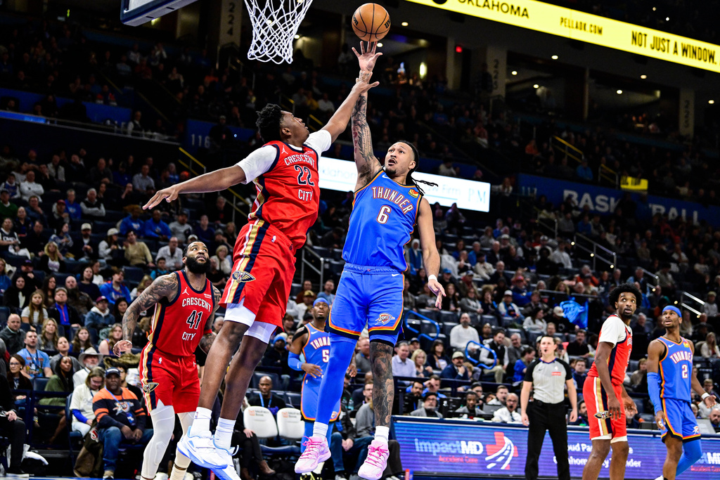 Oklahoma City Thunder forward Jaylin Williams (6) shoots against New Orleans Pelicans center Derik Queen (22) during the second half of an NBA basketball game Tuesday, Jan. 27, 2026, in Oklahoma City. (AP Photo/Gerald Leong)