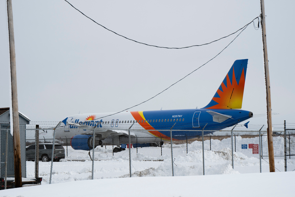 Snow is piled up at the Philadelphia International Airport on Monday, Feb. 23, 2026, in Philadelphia. (AP Photo/Joe Lamberti)