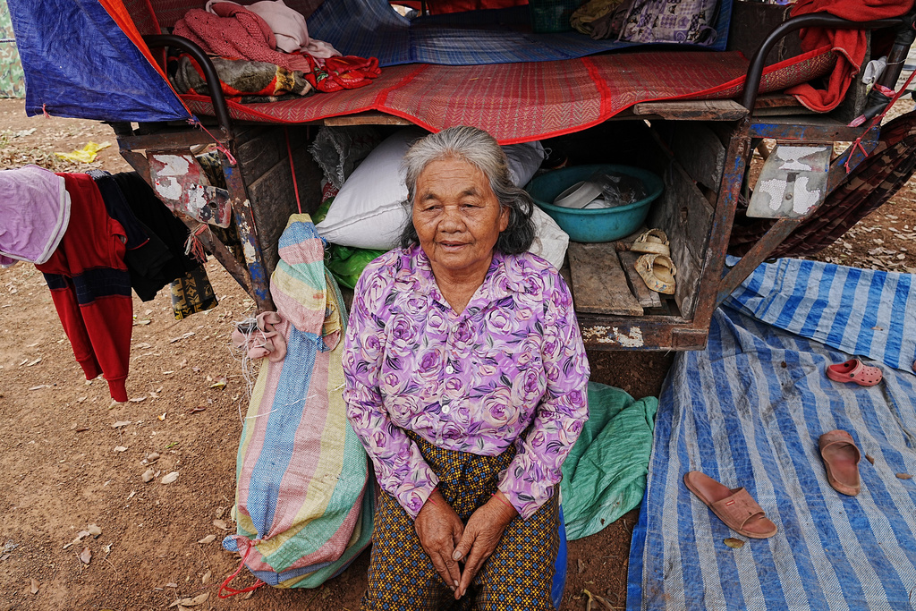 An evacuated elderly woman sits in a tent as she takes refuge in Batthkoa primary school in Oddar Meanchey province, Cambodia, Wednesday, Dec. 10, 2025, after fleeing home following fighting between Thailand and Cambodia over territorial claims. (AP Photo/Heng Sinith)