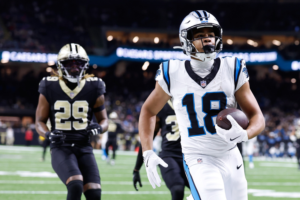 Carolina Panthers wide receiver Jalen Coker (18) runs in for a touchdown in the second half of an NFL football game against the New Orleans Saints, Sunday, Dec. 14, 2025, in New Orleans. (AP Photo/Butch Dill)