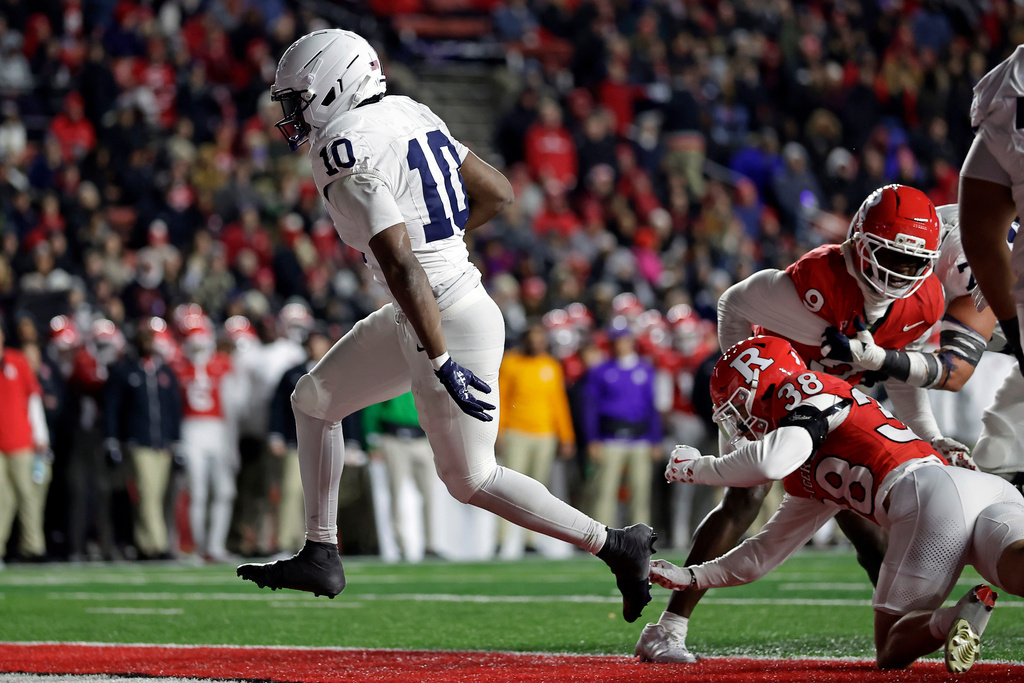 Penn State running back Nicholas Singleton (10) scores a touchdown past Rutgers defensive back Timmy Ward (38) during the second half of an NCAA college football game Saturday, Nov. 29, 2025, in Piscataway, N.J. (AP Photo/Adam Hunger)