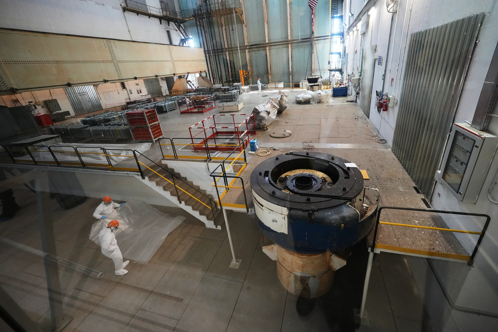 Workers package reactor components on the reactor operating floor of the former nuclear power plant of Latina, Italy, Thursday, June 18, 2026. (AP Photo/Alessandra Tarantino)