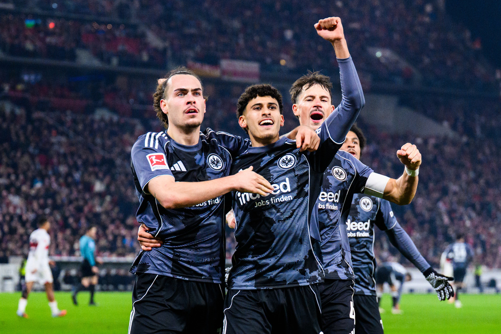 Frankfurt's Ayoube Amaimouni-Echghouyab celebrates scoring with Arthur Theate, left, and Robin Koch, right, during the Bundesliga soccer match between VfB Stuttgart and Eintracht Frankfurt in Stuttgart, Germany, Tuesday Jan. 13, 2026. (Tom Weller/dpa via AP)