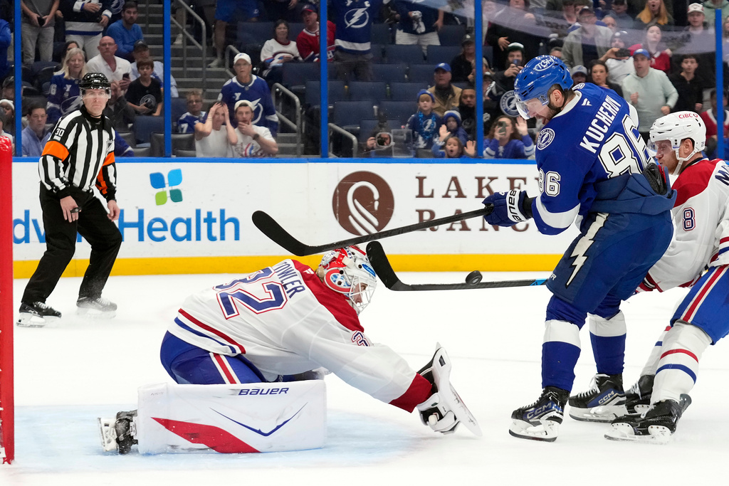 Montréal Canadiens goaltender Jacob Fowler (32) stops a shot by Tampa Bay Lightning right wing Nikita Kucherov (86) during overtime in an NHL hockey game Sunday, Dec. 28, 2025, in Tampa, Fla. (AP Photo/Chris O'Meara)