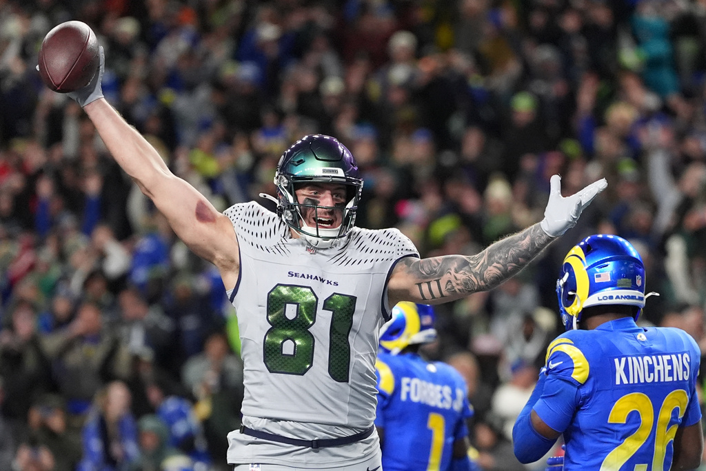 Seattle Seahawks tight end Eric Saubert (81) celebrates after making a two-point conversion during overtime in an NFL football game against the Los Angeles Rams, Thursday, Dec. 18, 2025, in Seattle. (AP Photo/Lindsey Wasson)