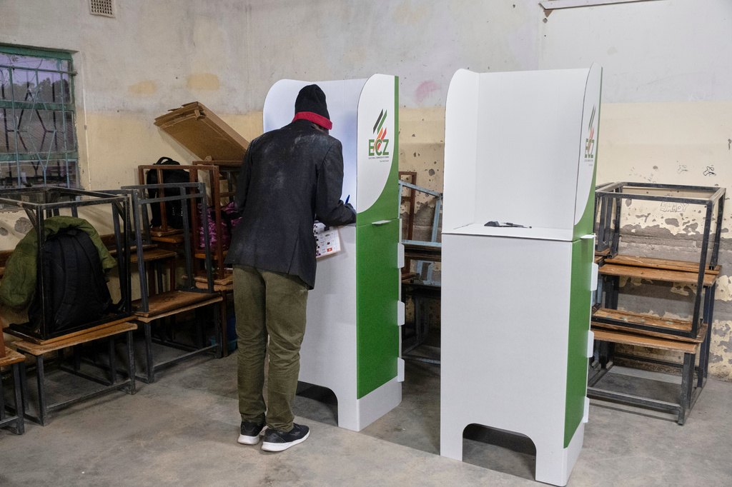 A man is seen in a voting booth at a polling station during a presidential election in Lusaka, Zambia, Thursday, Aug. 13, 2026. (AP Photo/Anita Reed)
