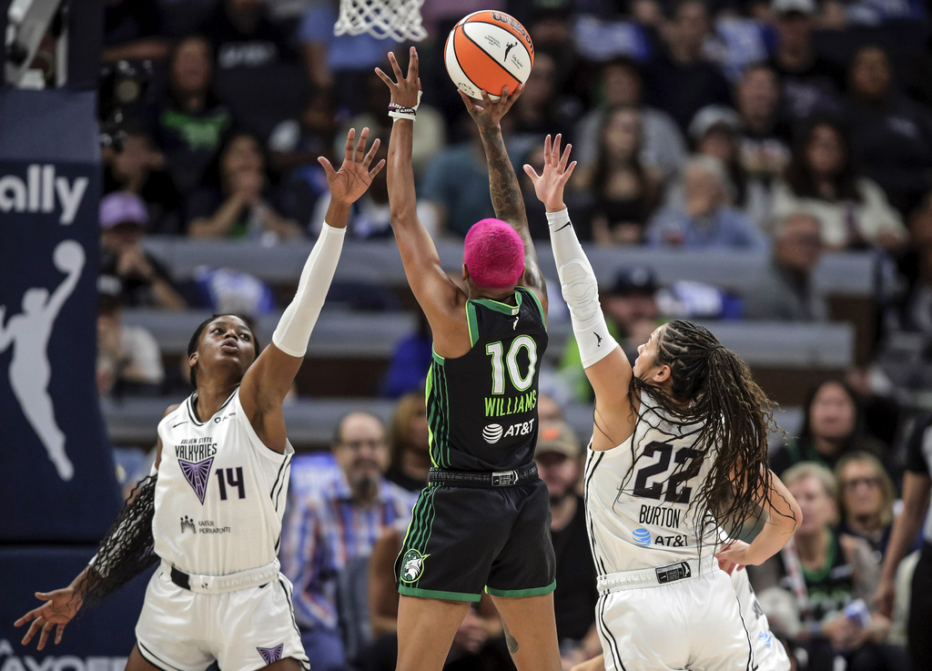 Veronica Burton (22) and Temi Fágbénlé (14) defend against Courtney Williams (10) in the first half as the Golden State Valkyries played the Minnesota Lynx in Game 1 of the WNBA first round playoffs at Target Center in Minneapolis, Minn., on Sunday, Sept. 14, 2025. (Carlos Avila Gonzalez/San Francisco Chronicle via AP)