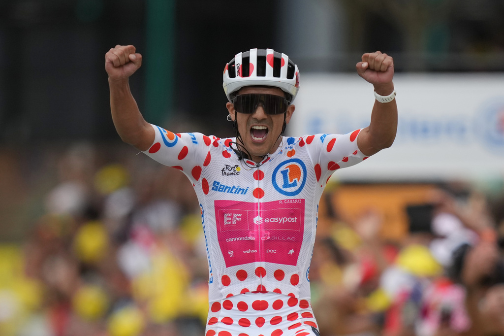 Ecuador's Richard Carapaz celebrates as he crosses the finish line to win the twentieth stage of the Tour de France cycling race with start in Le Bourg d'Oisans and finish in Alpe d'huez, France, Saturday, July 25, 2026. (AP Photo/Mosa'ab Elshamy)