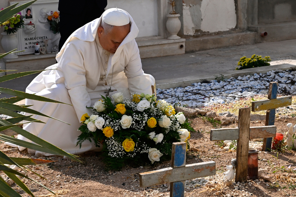 Pope Leo XIV pays tribute at the cemetery and on little Joussef's grave, in Lampedusa, Sicily, southern Italy, Saturday, July 4, 2026, during a one-day pastoral visit to an island that has become a symbol of the risks faced by migrants trying to reach Europe by sea.(Pool Photo/Ciro Fusco, Via AP)