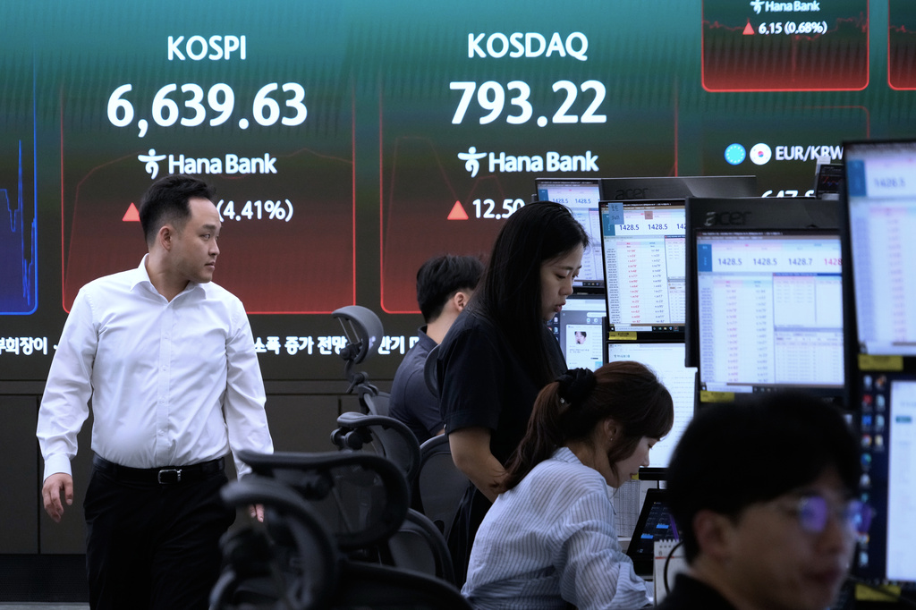 Currency traders work near a screen showing the Korea Composite Stock Price Index (KOSPI) at the foreign exchange dealing room of the Hana Bank headquarters in Seoul, South Korea, Wednesday, Aug. 5, 2026. (AP Photo/Ahn Young-joon)