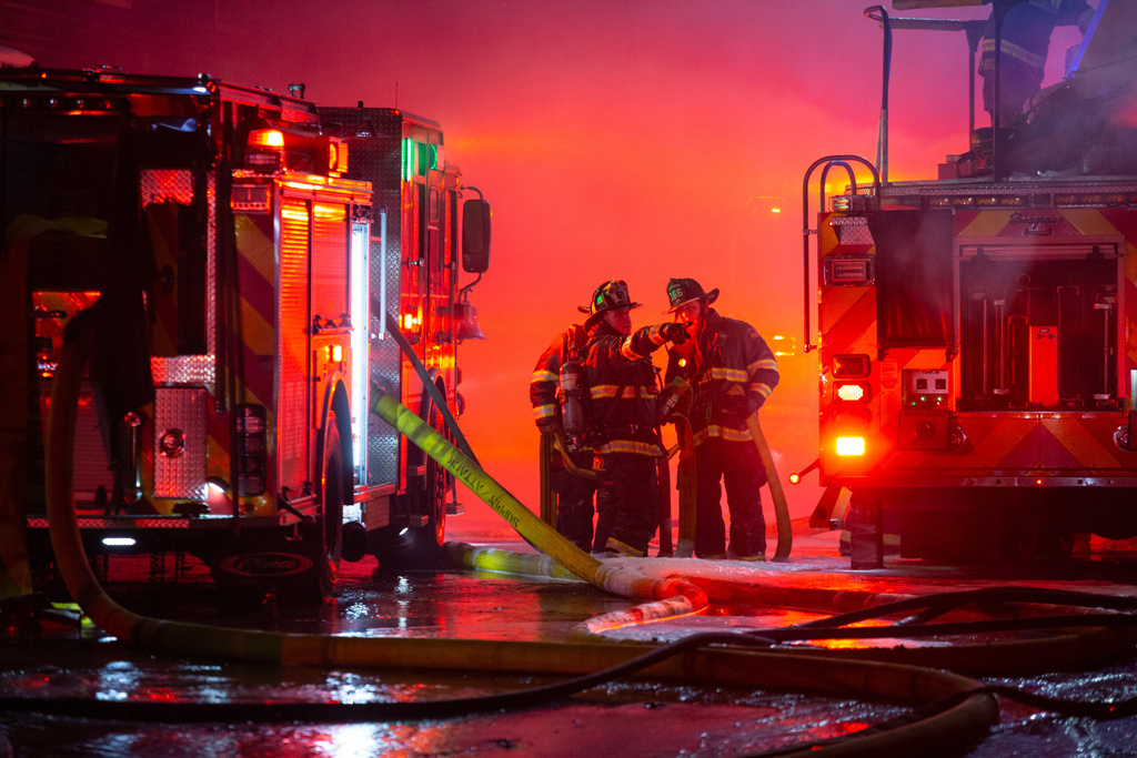 Firefighters battle a three-alarm fire on the historic Old Port waterfront late Friday, Dec. 27, 2025 in Portland, Maine. (Libby Kamrowski Kenny /Portland Press Herald via AP)