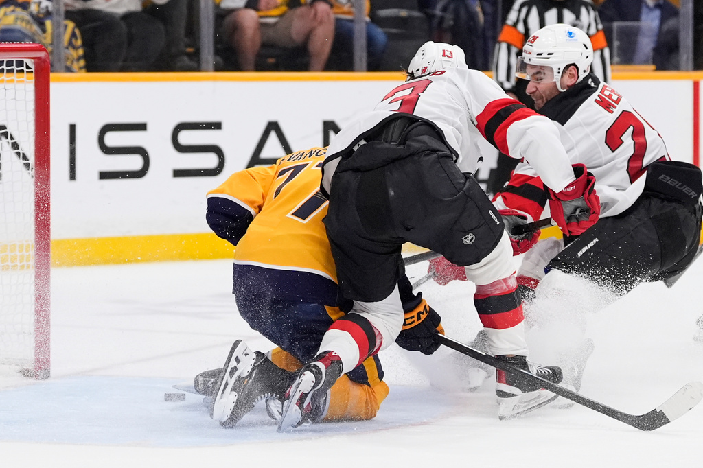 New Jersey Devils right wing Timo Meier, right, scores a goal past Nashville Predators right wing Luke Evangelista, left, during the third period of an NHL hockey game Thursday, March 26, 2026, in Nashville, Tenn. (AP Photo/George Walker IV)