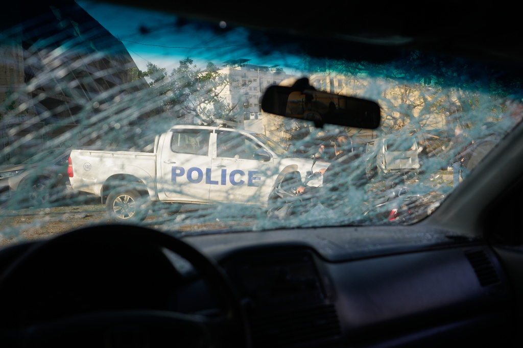 A police vehicle is seen through a shattered windshield at the site of an Israeli strike in Beirut, Lebanon, Wednesday, April 1, 2026. (AP Photo/Hassan Ammar)